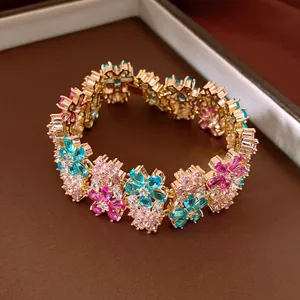 Detail shot of 18k gold plated luxury bracelet featuring colorful zircon flower clusters