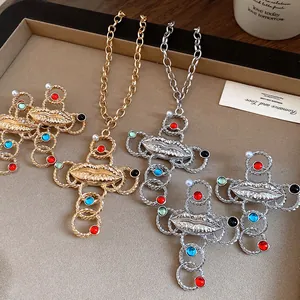 Detailed view of vintage resin lip cross necklaces featuring gold and silver finishes.