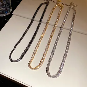 Three minimalist double-row rhinestone tennis necklaces in gold, silver, and black tone.