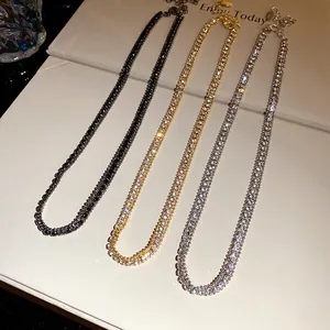 Macro view of three sparkling rhinestone tennis necklaces in gold, silver, and black finish