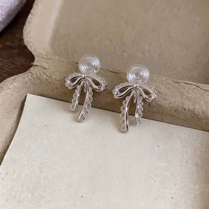 Elegant silver lace bowknot clip-on earrings featuring sparkling crystal accents for women
