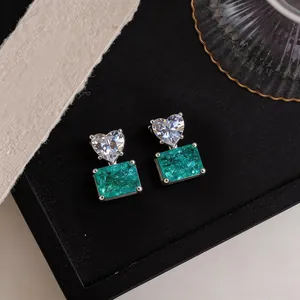 Elegant heart and rectangular green stone stud earrings with silver setting details.