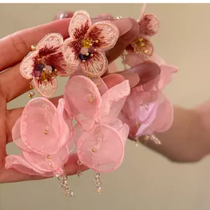 Close-up of elegant pink floral beaded tassel earrings featuring delicate mesh petals