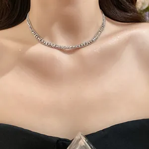 Detailed view of an elegant double-strand rhinestone choker necklace on the model's neck