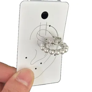 Elegant double-layered silver ear cuff with white pearls and sparkling pave rhinestones