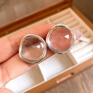 Close-up macro view of minimalist circular resin stud earrings with irregular silver rims