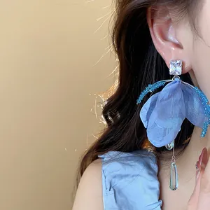 Detailed macro view of a light blue chiffon flower earring with zircon and glass waterdrop