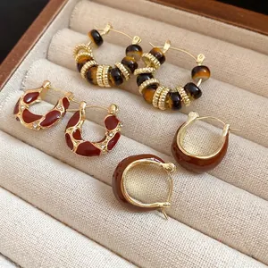 Set of three retro-style hoop earrings with resin and rhinestones in a jewelry box