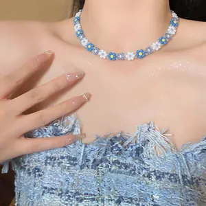 Detail of a Korean-style blue and white flower beaded choker necklace on a model
