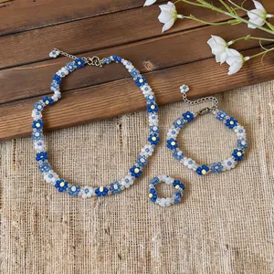 Elegant blue and white flower beaded jewelry set including necklace, bracelet and ring.