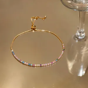 Detail view of a gold adjustable bracelet featuring a row of colorful square zircons.