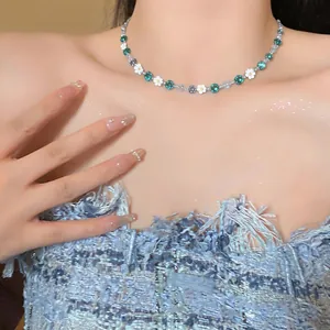 Exquisite detail of a floral beaded stainless steel necklace worn on a model's neck