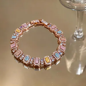 Macro detail of a rose gold bracelet with pastel rectangular zircons and pave accents