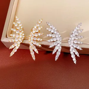 Close-up of 18k gold plated wing ear clips featuring shimmering cubic zirconia stones