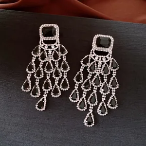Detail of vintage chandelier earrings featuring black teardrop stones and rhinestones