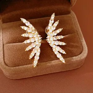 Detailed macro view of 18k gold plated wing ear cuffs with cubic zirconia