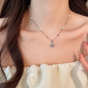 Elegant Korean style silver necklace with pearl and floral zircon pendant on a model