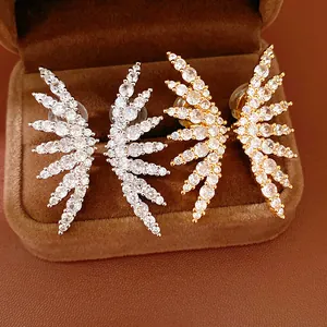Detail view of 18k gold plated zircon wing ear clips in silver and gold finish