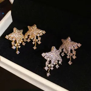 Exquisite star stud earrings set with shimmering crystals in gold and silver finish