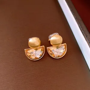 Detailed view of French vintage semi-circle clip earrings with champagne crystals