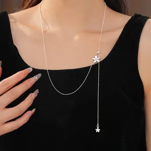 Minimalist silver flower adjustable drawstring necklace worn by a model