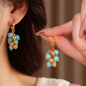 Vintage 18k gold plated drop earrings with blue resin beads and textured gold accents