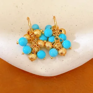 Vintage 18k gold plated earrings with blue resin beads and textured gold charms