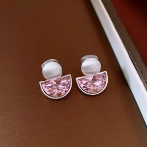 Macro view of French retro semi-circular clip-on earrings with pink faceted stones
