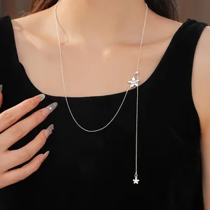 Close-up of elegant silver floral pull-through necklace on model wearing black top