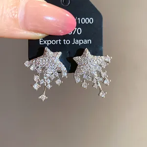 Detailed shot of sparkling star-shaped silver stud earrings with crystals
