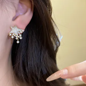 Detail view of star-shaped stud earrings with sparkling crystals and silver needles