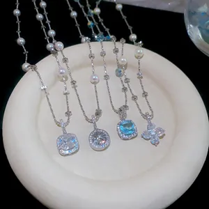 Detailed view of elegant zircon and pearl necklaces featuring flower and geometric pendants