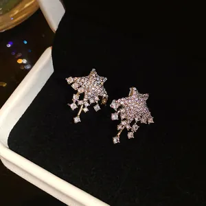 Detailed view of sparkling star-shaped stud earrings encrusted with micro-pave crystals