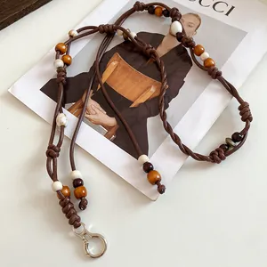 Close-up of vintage ethnic waist chain featuring wooden beads and brown leather cord