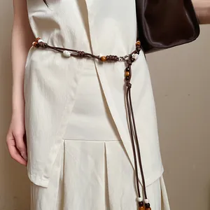Detail of a vintage ethnic style waist chain with leather cord and wooden beads.