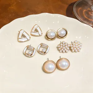 Detailed view of five-pair pearl and rhinestone geometric earring set