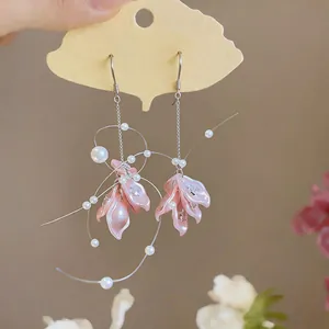 Close-up of elegant pink petal tassel earrings featuring white pearls and zircon