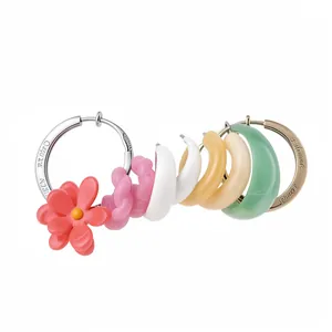 Vibrant resin flower and geometric hoop earrings set in a trendy dopamine color palette