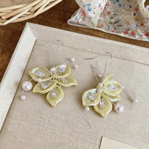 Close-up detail of elegant Korean style petal tassel earrings with pearls and zircons