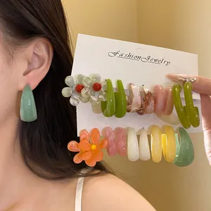 Detail view of a colorful resin geometric flower earrings set with model wearing effect