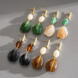 Detailed macro shot of vintage resin drop earrings with elegant geometric stone textures