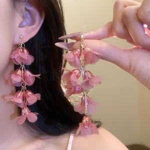 Close-up showing the delicate layered chiffon petals of pink bohemian flower drop earrings.