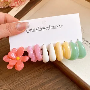 Set of dopamine colored resin flower and geometric hoop earrings on display card