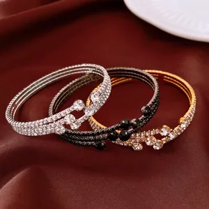 Close-up of vintage rhinestone elastic bangles in three elegant metallic finishes.