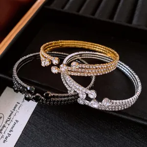 Macro view of vintage-style rhinestone elastic bracelets in gold, silver and black.