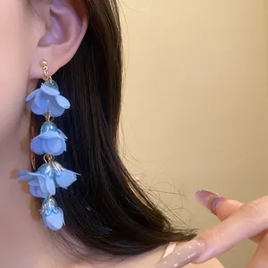 Detailed close-up of blue layered flower earrings in Bohemian style