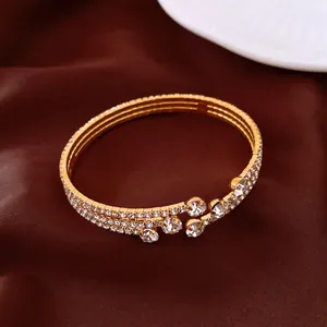 Close-up of a vintage gold-toned stretch bracelet with shimmering rows of rhinestones