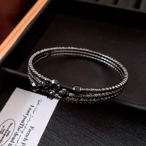 Close-up of vintage black rhinestone elastic open bangle with elegant crystal detail