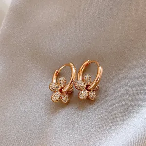 Macro view of exquisite rose gold flower hoop earrings with sparkling zircon paving detail