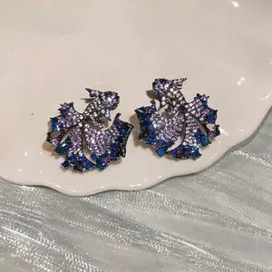 Elegant fish-shaped stud earrings with sparkling blue and purple zircon stones